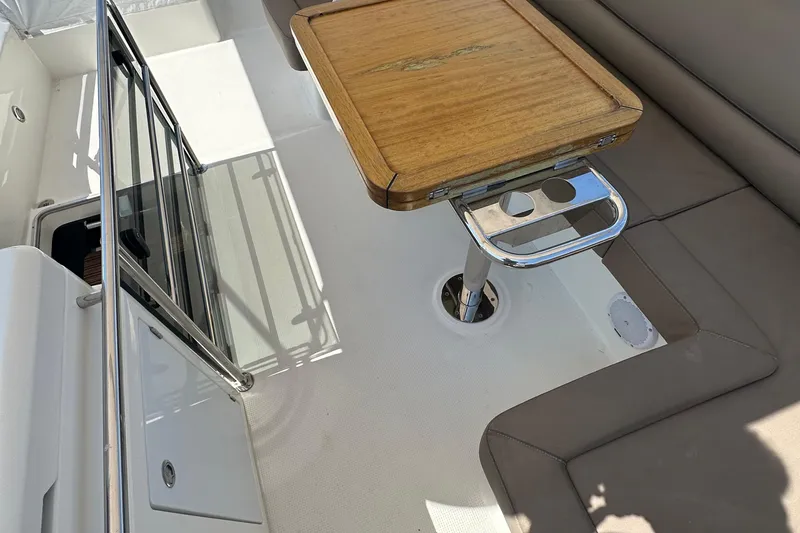 Sweet Yacht Photos Pics 2017 Bavaria Virtess 420 Fly yacht interior with wooden table and cushioned seating.