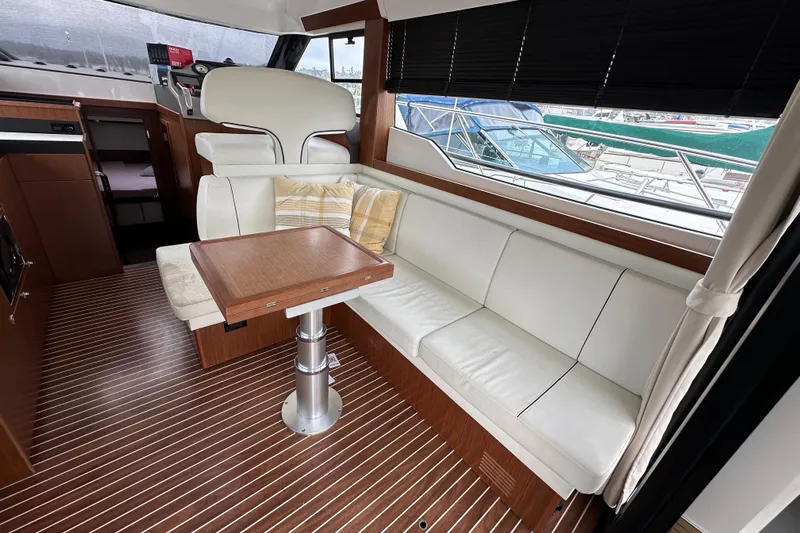Sweet Yacht Photos Pics Luxurious interior of 2017 Bavaria Virtess 420 Fly yacht with white seating and wooden accents.