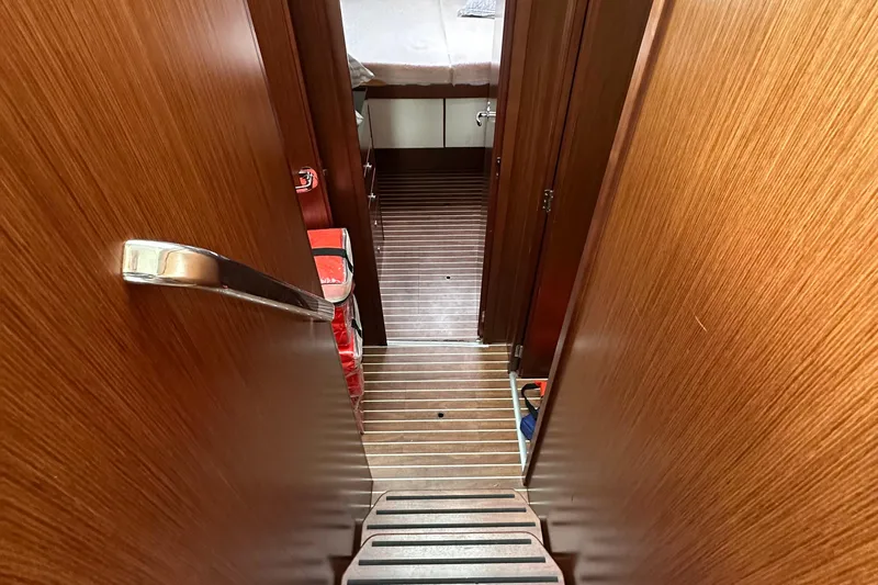 Sweet Yacht Photos Pics Interior view of 2017 Bavaria Virtess 420 Fly yacht, featuring wooden flooring and cabin access.
