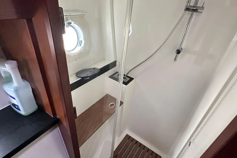 Sweet Yacht Photos Pics Shower area in 2017 Bavaria Virtess 420 Fly yacht with modern fixtures and porthole.
