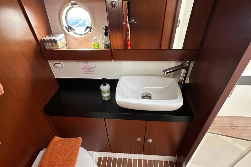 Sweet Yacht Photos Pics Luxurious bathroom interior of 2017 Bavaria Virtess 420 Fly yacht with modern sink and porthole.