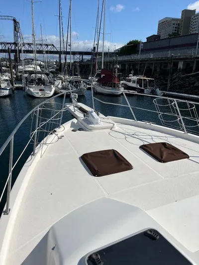 Magna Veritas Yacht Photos Pics 1996 Bayliner 4788 yacht docked in marina, surrounded by other boats.