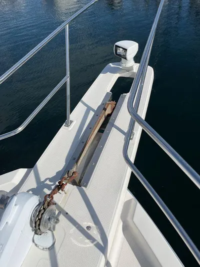 Magna Veritas Yacht Photos Pics Bow of 1996 Bayliner 4788 yacht with anchor and railing.