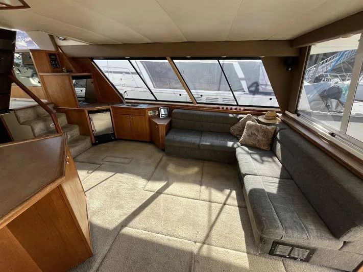 Magna Veritas Yacht Photos Pics Spacious interior of 1996 Bayliner 4788 yacht with plush seating and large windows.