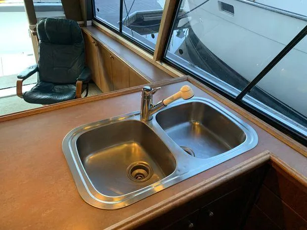 Magna Veritas Yacht Photos Pics Stainless steel sink in 1996 Bayliner 4788 yacht kitchen area.