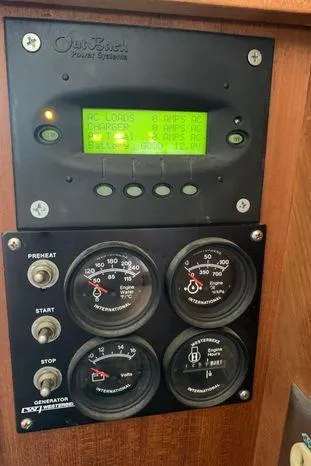 Magna Veritas Yacht Photos Pics Control panel of a 1996 Bayliner 4788 yacht with gauges and digital display.