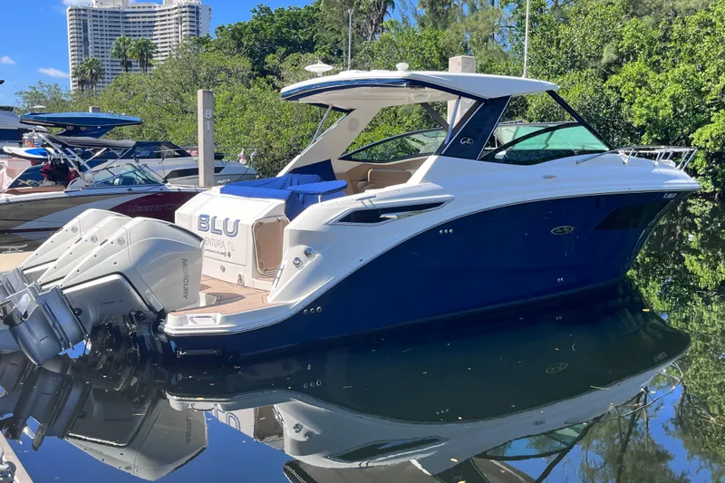 Blu Yacht Photos Pics 2020 Sea Ray Sundancer 320 Outboard docked, reflecting on calm water.