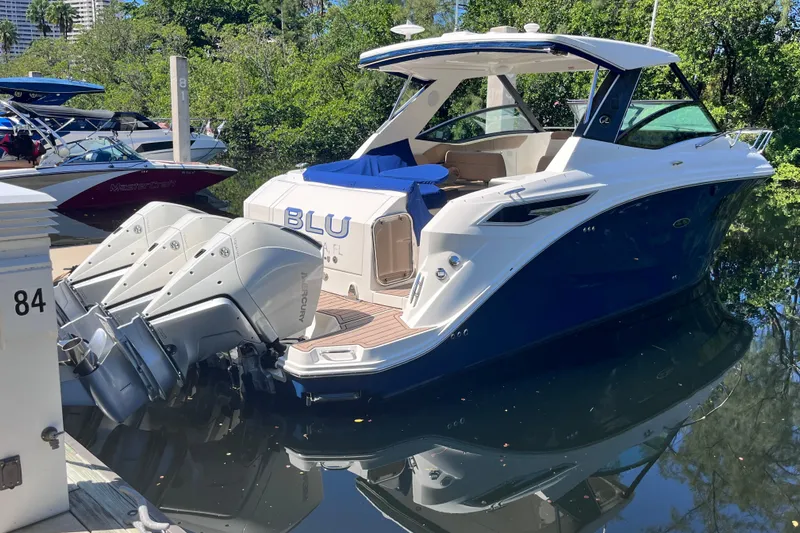 Blu Yacht Photos Pics 2020 Sea Ray Sundancer 320 Outboard docked, featuring triple Mercury engines.