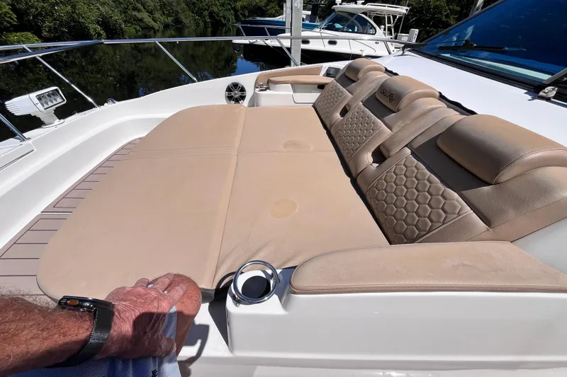 Blu Yacht Photos Pics 2020 Sea Ray Sundancer 320 Outboard with extra wide lounging area for three adults with head rests and arm rests on forward deck. Sound speakers and cupholders on both sides for added comfort.