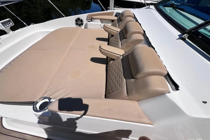 Blu Yacht Photos Pics 2020 Sea Ray Sundancer 320 Outboard with extra wide lounging area for three adults with head rests and arm rests on forward deck. Sound speakers and cupholders on both sides for added comfort.