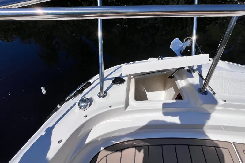 Blu Yacht Photos Pics 2020 Sea Ray Sundancer 320 Outboard bow with open storage compartment and railing.
