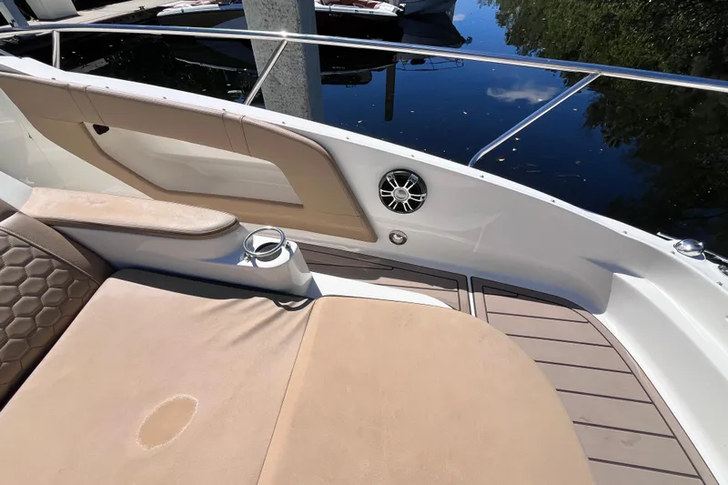 Blu Yacht Photos Pics 2020 Sea Ray Sundancer 320 Outboard interior with cushioned seating and cup holder.