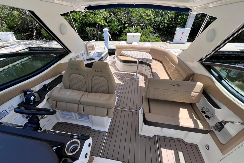 Blu Yacht Photos Pics Luxurious interior of 2020 Sea Ray Sundancer 320 Outboard with elegant seating and helm.
