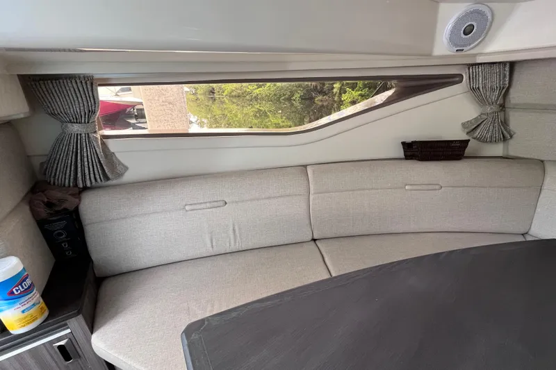 Blu Yacht Photos Pics Interior of 2020 Sea Ray Sundancer 320 Outboard with beige seating and window view.