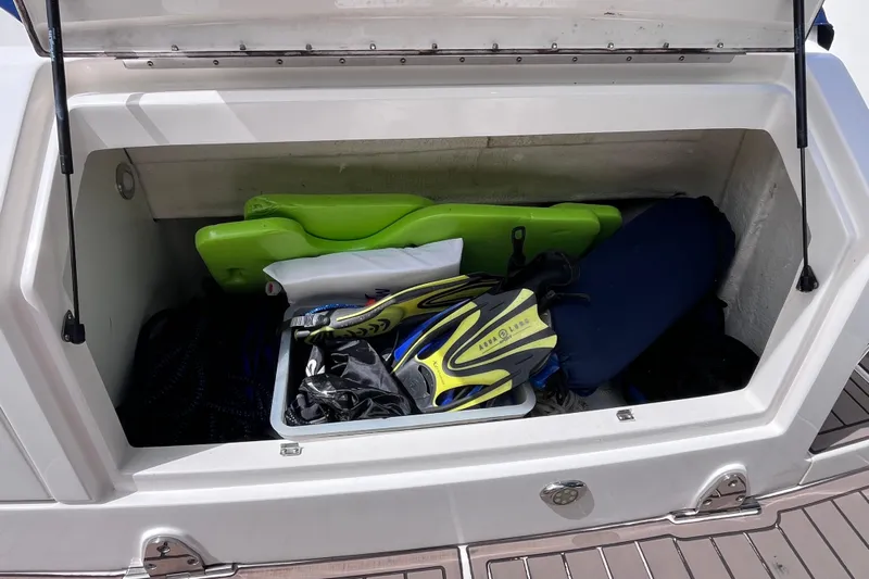 Blu Yacht Photos Pics Open storage compartment on 2020 Sea Ray Sundancer 320 Outboard with snorkeling gear and accessories.