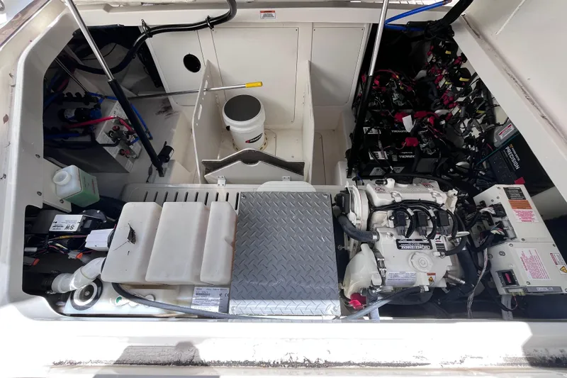 Blu Yacht Photos Pics Engine compartment of a 2020 Sea Ray Sundancer 320 Outboard, showcasing mechanical components and wiring.