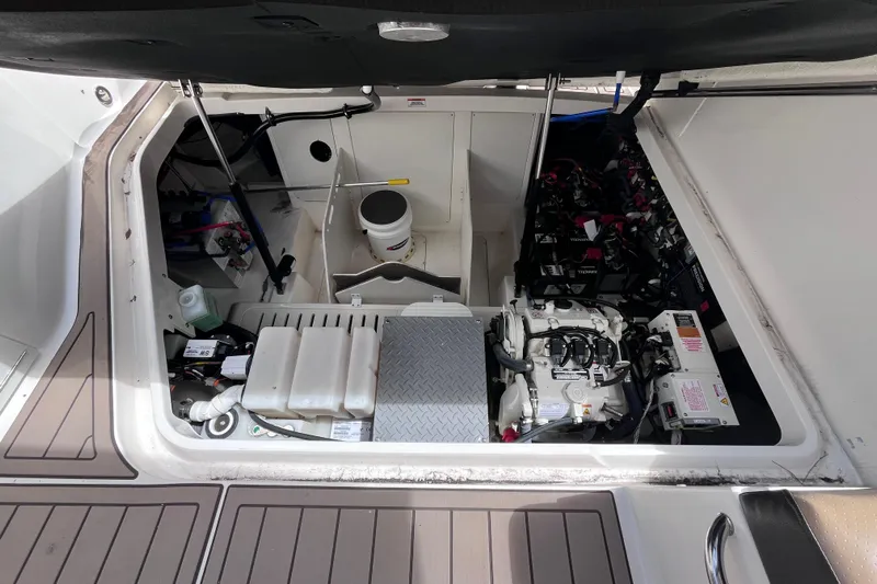 Blu Yacht Photos Pics Engine compartment of 2020 Sea Ray Sundancer 320 Outboard, showcasing mechanical components and storage.