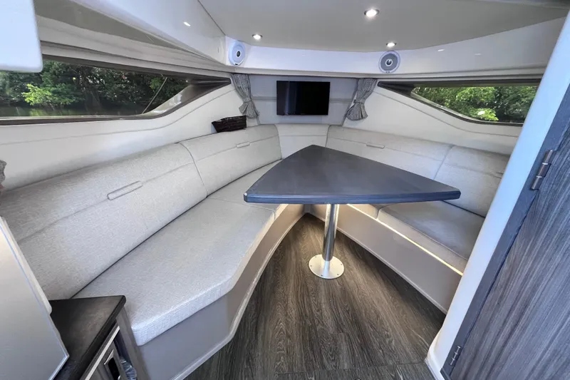 Blu Yacht Photos Pics 2020 Sea Ray Sundancer 320 Outboard interior with sleek seating and modern table design.