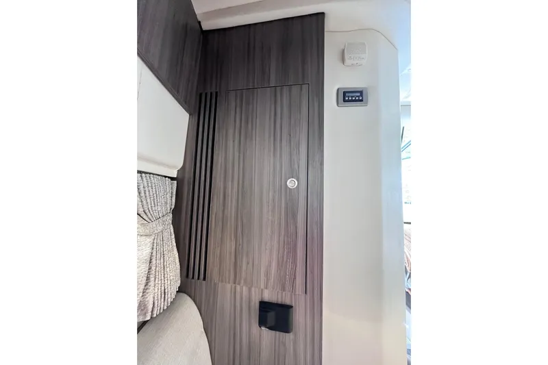 Blu Yacht Photos Pics 2020 Sea Ray Sundancer 320 Outboard interior with wood paneling and control panel.