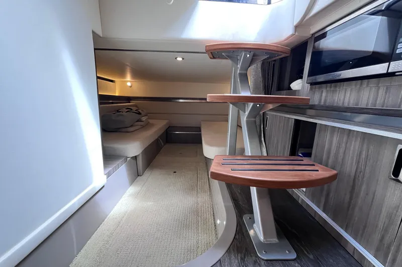 Blu Yacht Photos Pics 2020 Sea Ray Sundancer 320 Outboard interior with modern staircase and cozy seating area.