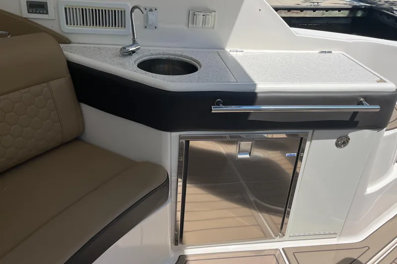 Blu Yacht Photos Pics 2020 Sea Ray Sundancer 320 Outboard interior with sink, countertop, and seating.