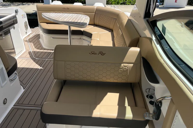 Blu Yacht Photos Pics 2020 Sea Ray Sundancer 320 Outboard interior with tan seating and a sleek table.
