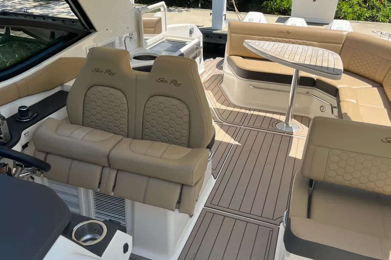 Blu Yacht Photos Pics 2020 Sea Ray Sundancer 320 Outboard interior with tan seating and wooden table.