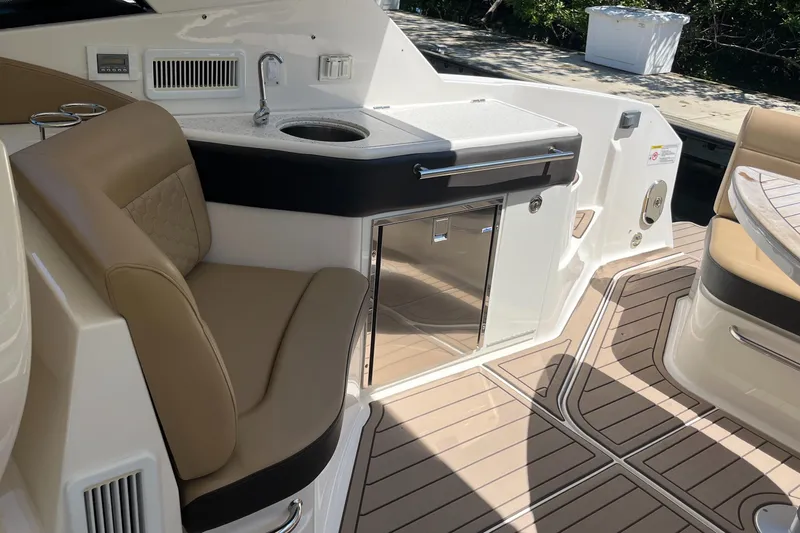 Blu Yacht Photos Pics 2020 Sea Ray Sundancer 320 Outboard interior with seating, sink, and storage.