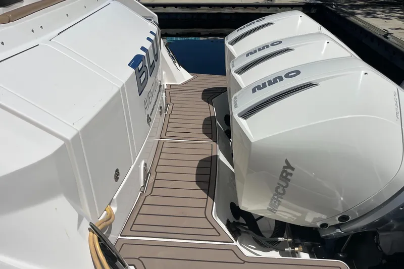 Blu Yacht Photos Pics 2020 Sea Ray Sundancer 320 Outboard with triple Mercury engines on a wooden deck.