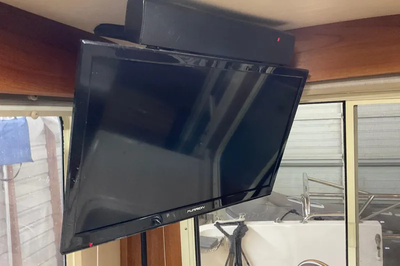 Hot Tuna Yacht Photos Pics Flat-screen TV mounted inside 2002 American Tug, Hull #24, near window.