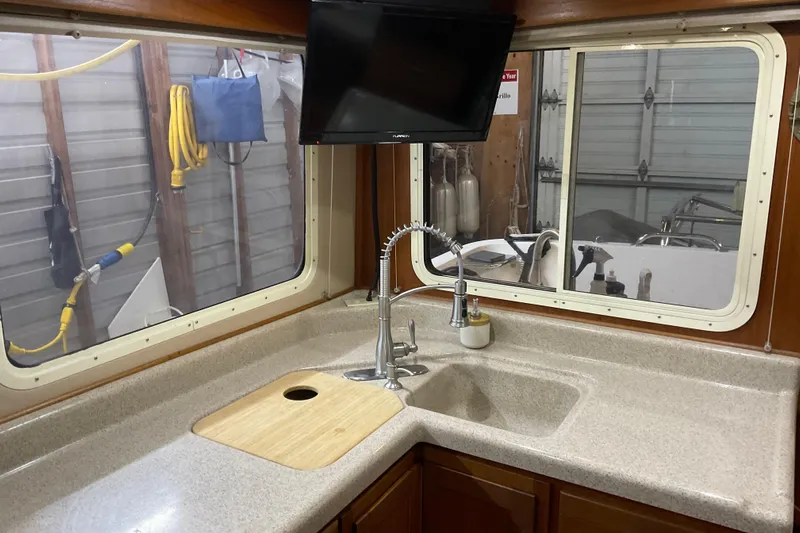 Hot Tuna Yacht Photos Pics American Tug 2002 Hull #24 kitchen with sink, countertop, and window view.