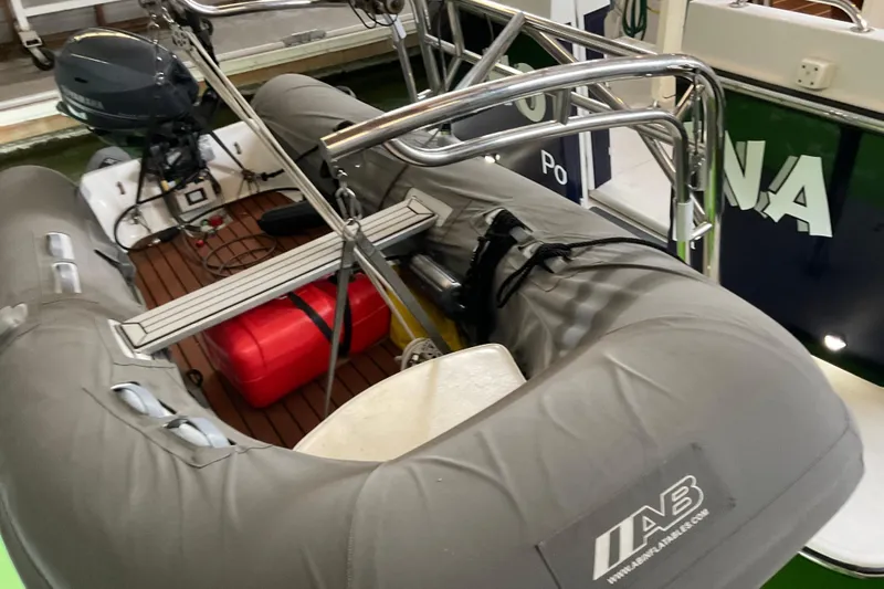 Hot Tuna Yacht Photos Pics Inflatable boat on American Tug Hull #24, 2002 model, with outboard motor and red fuel tank.