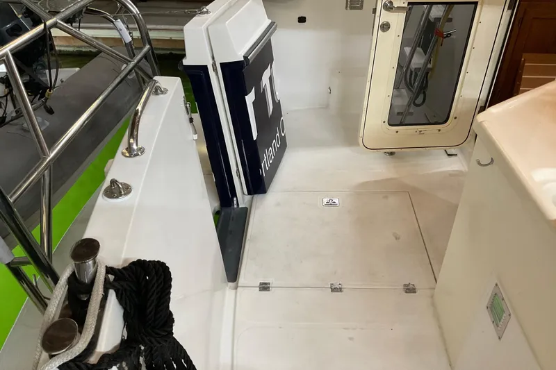 Hot Tuna Yacht Photos Pics 2002 American Tug Hull #24 deck with railing, ropes, and cabin door.