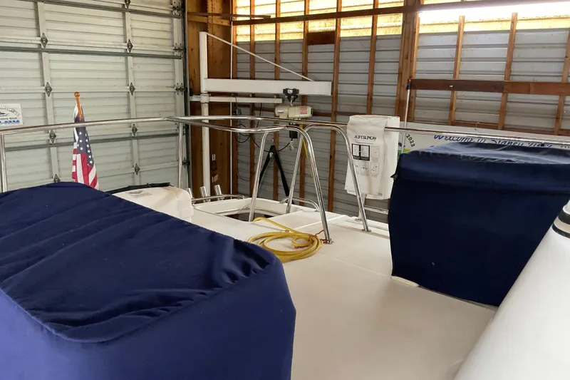 Hot Tuna Yacht Photos Pics American Tug Hull #24, 2002 model, in a garage with blue covers and an American flag.