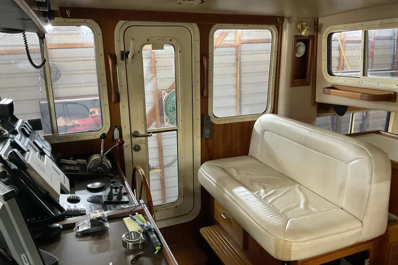 Hot Tuna Yacht Photos Pics Interior of 2002 American Tug Hull #24 with helm and seating area.