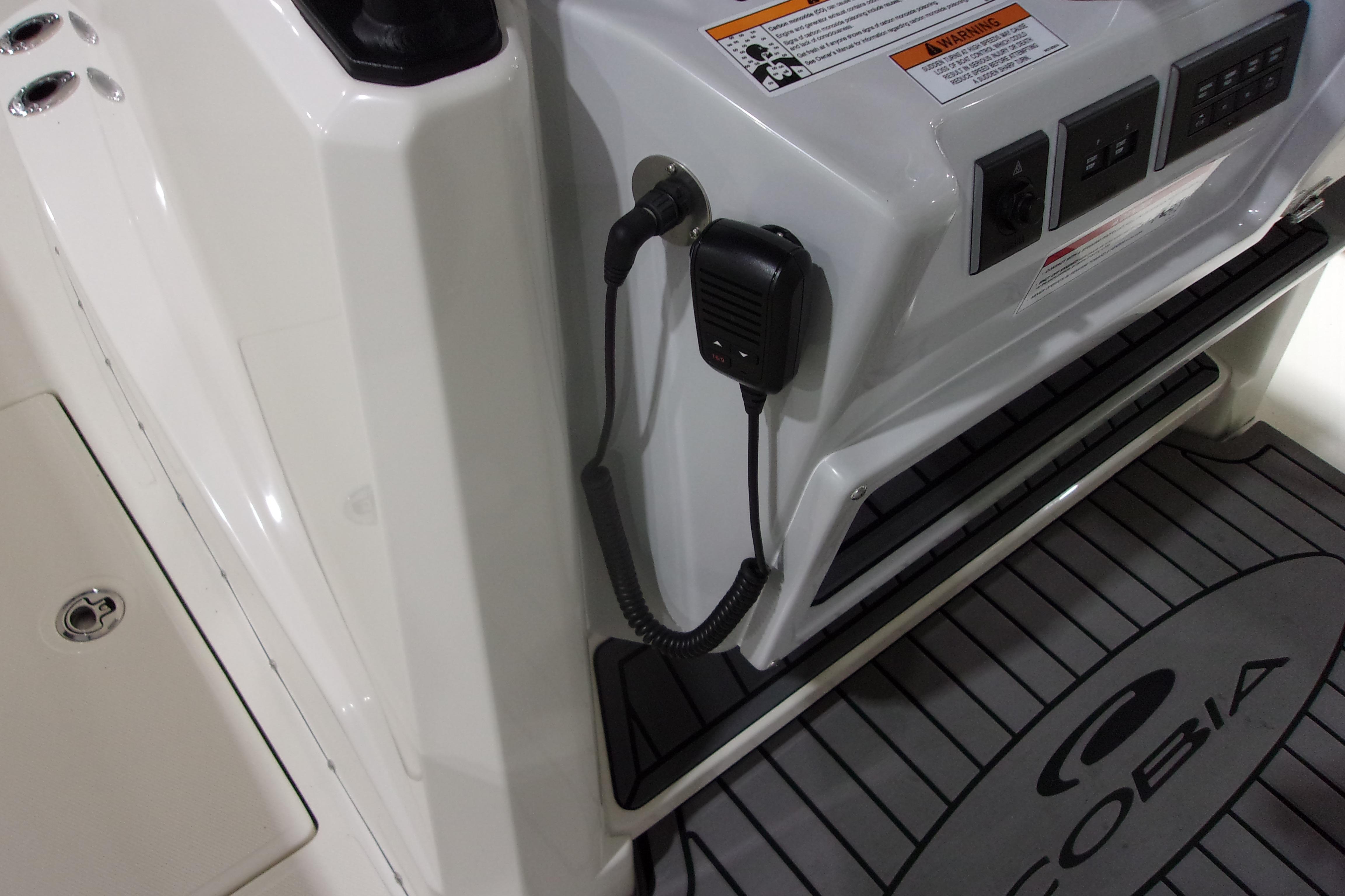 2026 Cobia 305 Center Console boat dashboard with controls and microphone.