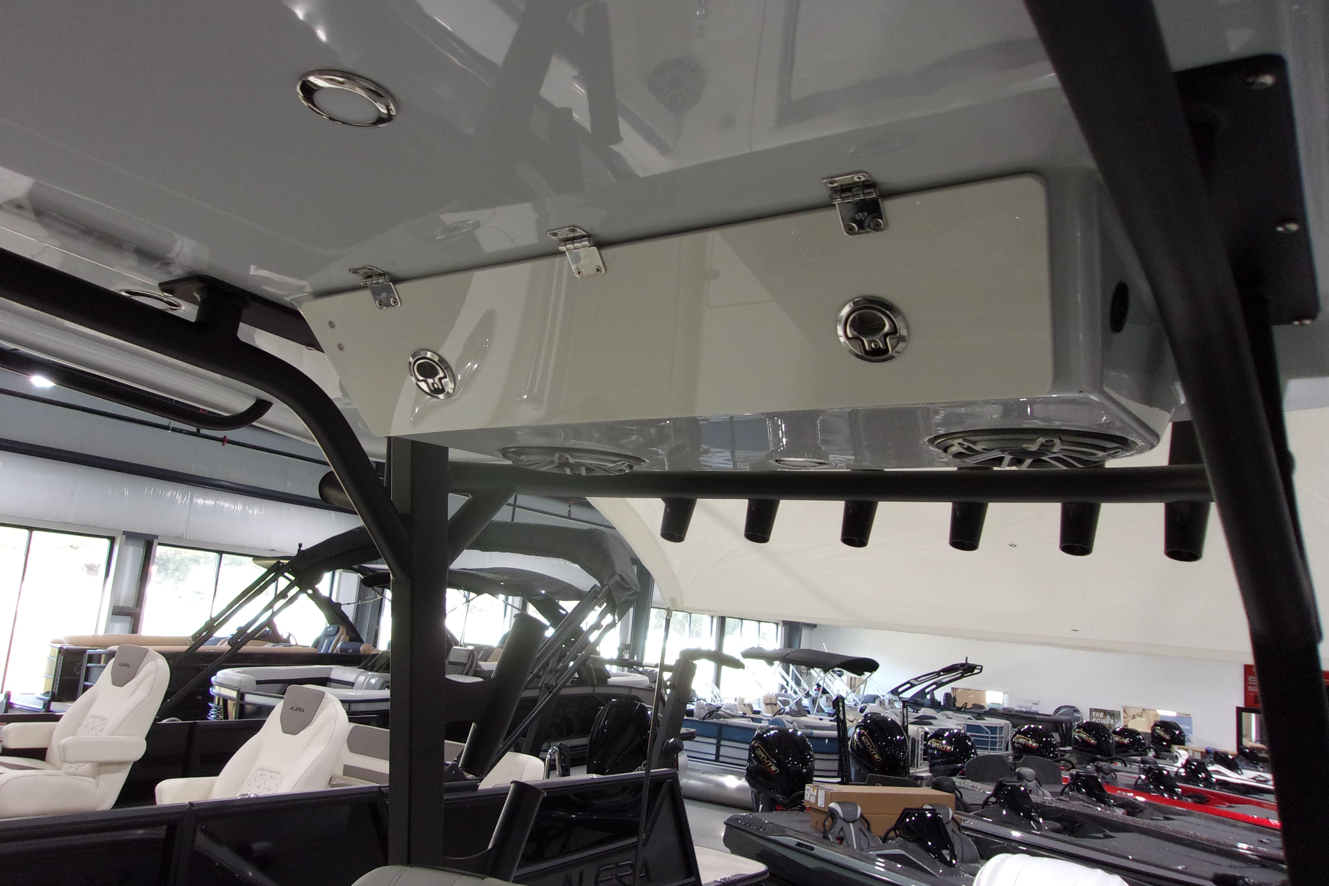 2026 Cobia 305 Center Console boat interior with rod holders and storage compartments.