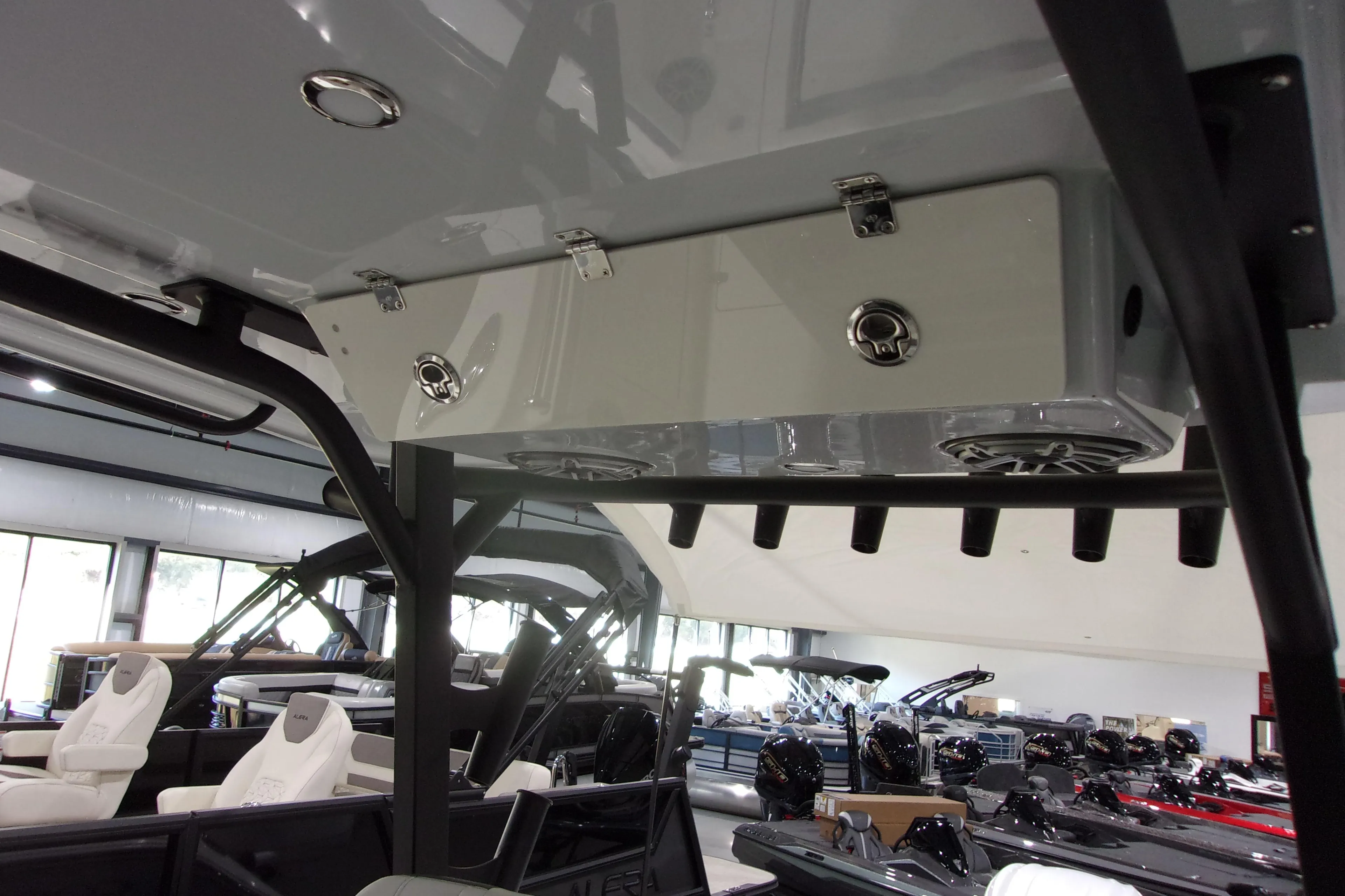 2026 Cobia 305 Center Console boat interior with rod holders and storage compartments.