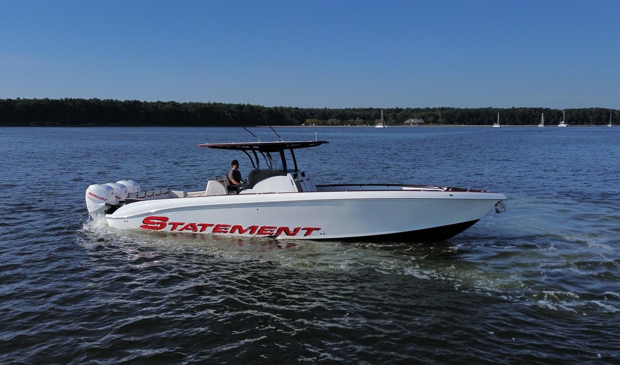 2017 Statement 380 Open boat cruising on a calm lake under a clear blue sky.