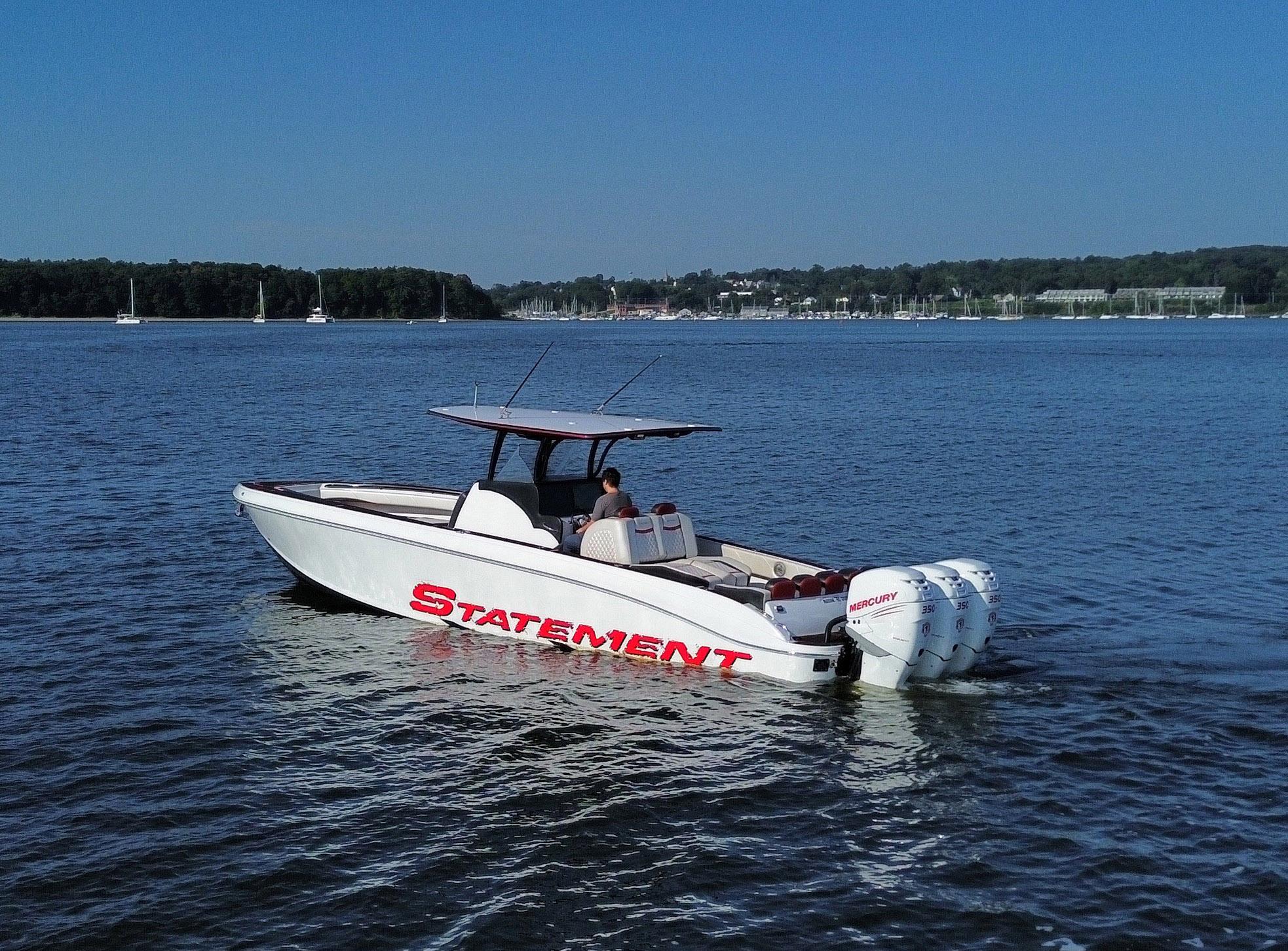 2017 Statement 380 Open boat cruising on a calm lake with scenic background.