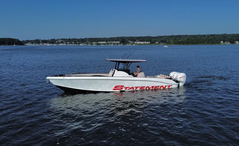 Heavy Metal Yacht Photos Pics 2017 Statement 380 Open boat cruising on a calm lake under a clear blue sky.