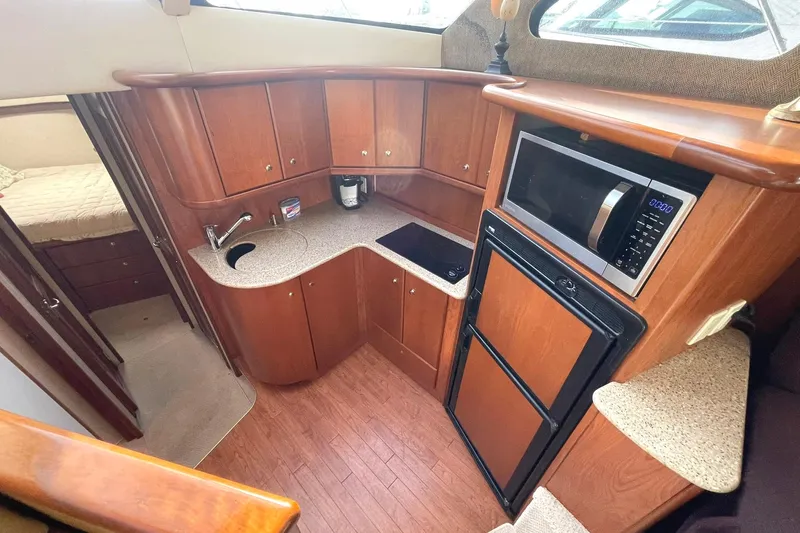 Hobe Yacht Photos Pics 2007 Silverton 34 Convertible galley with wood cabinetry, microwave, and compact appliances.