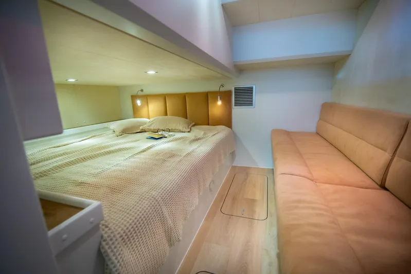 Explorer 1 Yacht Photos Pics Luxurious interior of 2024 Ridas 62, featuring a cozy bed and comfortable seating area.