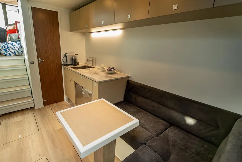 Explorer 1 Yacht Photos Pics Modern interior of 2024 Ridas 62 with kitchenette and cozy seating area.