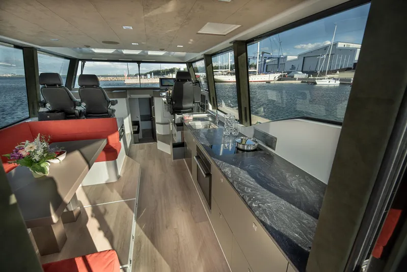 Explorer 1 Yacht Photos Pics Luxurious interior of 2024 Ridas 62 yacht with modern kitchen and seating area.