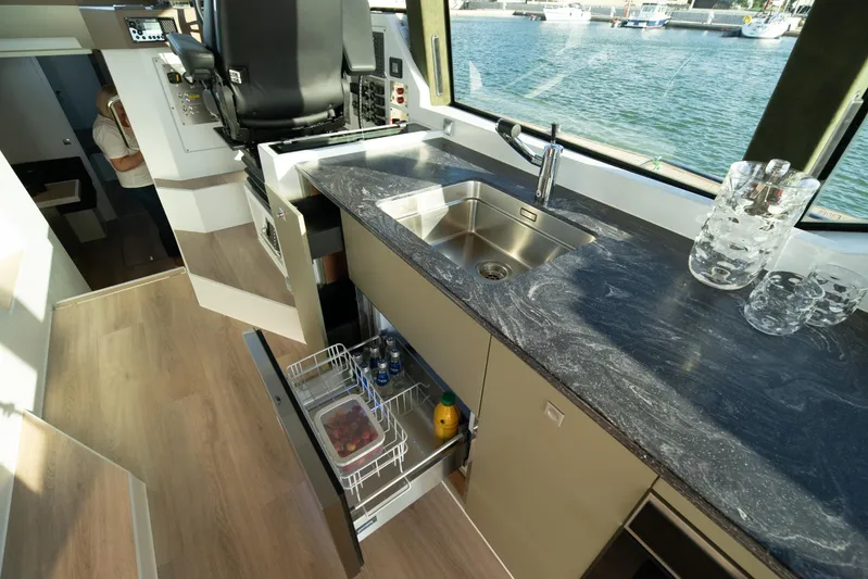 Explorer 1 Yacht Photos Pics Modern kitchen interior on 2024 Ridas 62 yacht with sleek countertops and open storage.