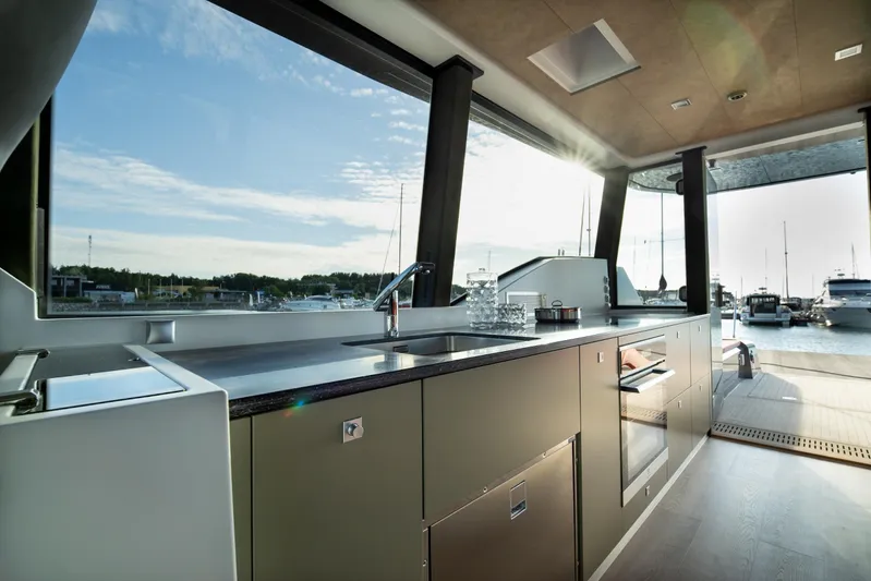 Explorer 1 Yacht Photos Pics Modern kitchen interior on 2024 Ridas 62 yacht with marina view.