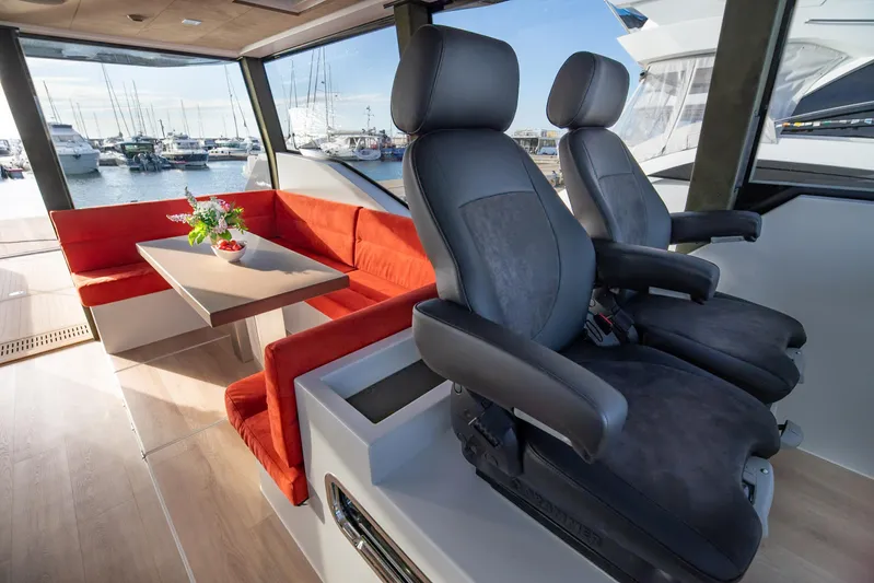 Explorer 1 Yacht Photos Pics Luxurious interior of 2024 Ridas 62 yacht with red seating and modern helm chairs.