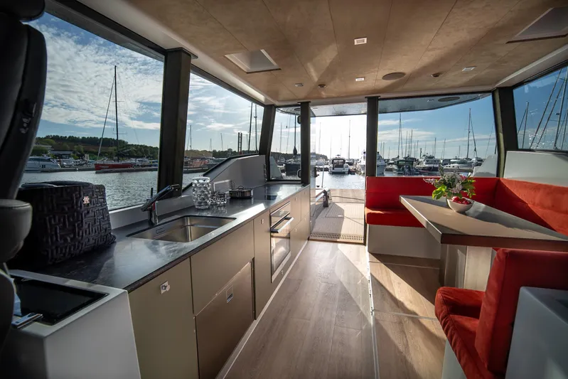 Explorer 1 Yacht Photos Pics Luxurious interior of 2024 Ridas 62 yacht with modern kitchen and dining area.
