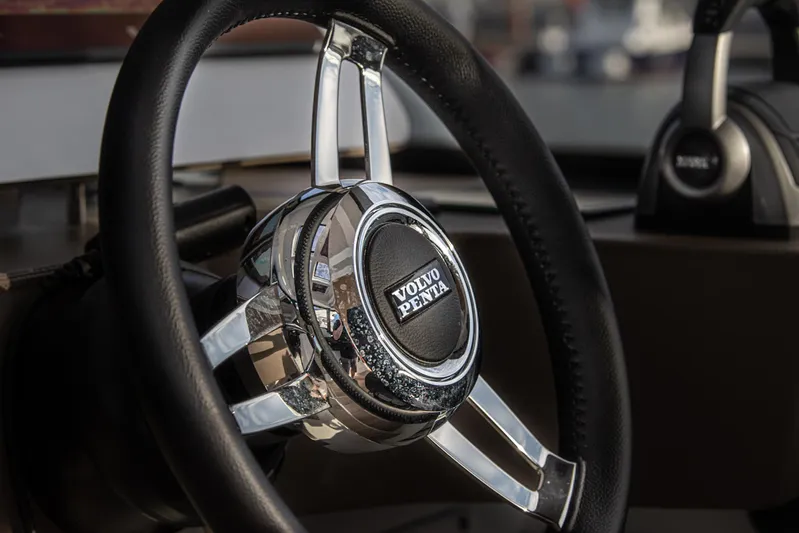 Explorer 1 Yacht Photos Pics Steering wheel of 2024 Ridas 62 with Volvo Penta emblem, close-up view.